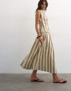 Model wearing Co-ord dropped waist deep v maxi skirt in buttermilk stripe