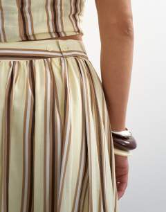 Model wearing Co-ord dropped waist deep v maxi skirt in buttermilk stripe