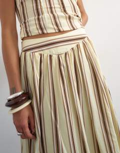 Model wearing Co-ord dropped waist deep v maxi skirt in buttermilk stripe