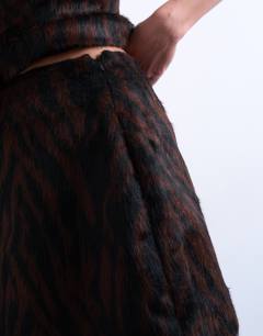 Model wearing Co-ord faux fur pelmet mini skirt in brown animal print