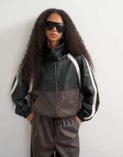 Model wearing Co-ord faux leather colour block jacket in black