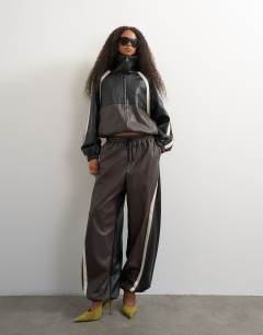 Model wearing Co-ord faux leather colour block jacket in black