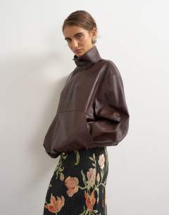 Model wearing Co-ord faux leather funnel neck bubble hem top in chocolate
