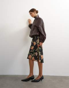 Model wearing Co-ord faux leather funnel neck bubble hem top in chocolate