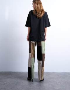 Model wearing Co ord  faux suede patchwork cinch trousers in multi