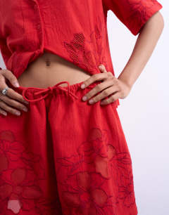Model wearing Co ord floral applique short in red