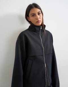 Model wearing Co ord funnel neck jacket in black 