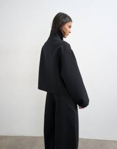 Model wearing Co ord funnel neck jacket in black 