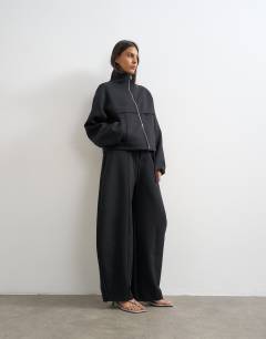 Model wearing Co ord funnel neck jacket in black 