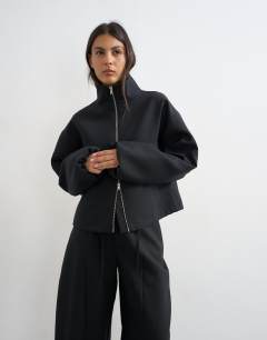Model wearing Co ord funnel neck jacket in black 