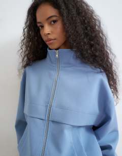 Model wearing Co ord funnel neck jacket in blue