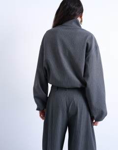 Model wearing Co ord funnel neck jacket in charcoal stripe