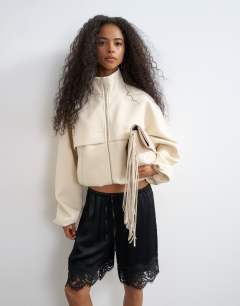 Model wearing Co ord funnel neck jacket in ecru