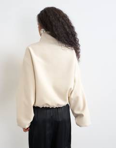 Model wearing Co ord funnel neck jacket in ecru