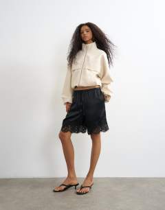 Model wearing Co ord funnel neck jacket in ecru