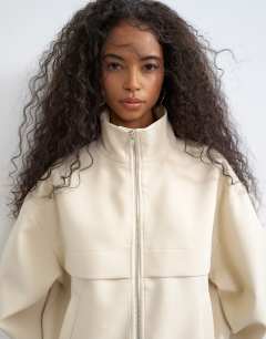 Model wearing Co ord funnel neck jacket in ecru