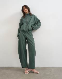 Model wearing Co ord funnel neck jacket in green stripe