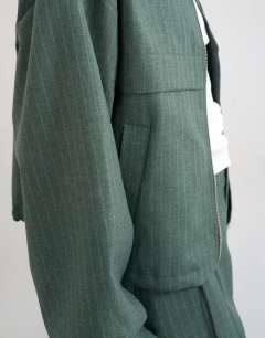 Model wearing Co ord funnel neck jacket in green stripe