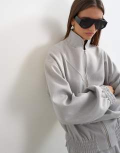 Model wearing Co ord funnel neck jacket in grey 