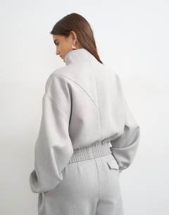 Model wearing Co ord funnel neck jacket in grey 