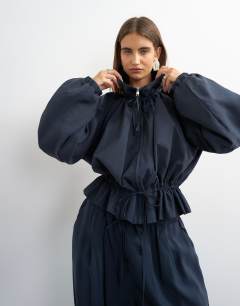 Model wearing Co ord funnel neck jacket with tie waist in navy