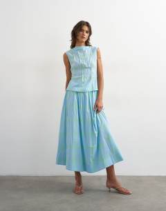Model wearing Co-ord grown on neck pin tuck top in blue check