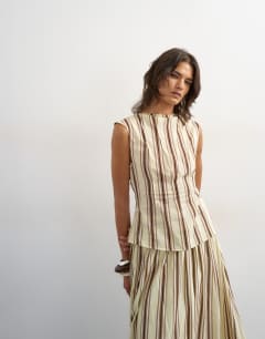 Model wearing Co-ord grown on neck pin tuck top in buttermilk stripe