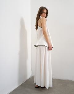 Model wearing Co-ord heavy linen rich maxi skirt with black contrast piping in white