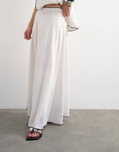Model wearing Co-ord heavy linen rich maxi skirt with black contrast piping in white
