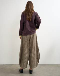 Model wearing Co-ord horseshoe trouser in check