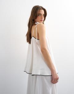 Model wearing Co-ord linen rich cami top with black contrast in off white