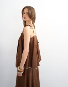 Model wearing Co-ord linen rich cami top with ecru contrast piping in brown