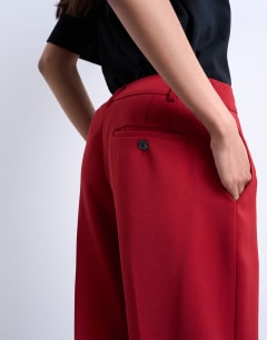 Model wearing Co ord mid rise clean straight trouser in cherry red