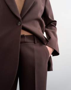Model wearing Co ord mid rise clean straight trouser in chocolate