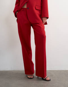 Model wearing Co ord mid rise clean straight trouser in red