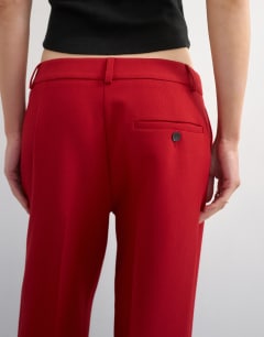 Model wearing Co ord mid rise clean straight trouser in red