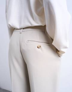 Model wearing Co ord mid rise clean straight trouser in stone