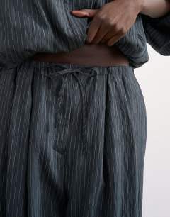 Model wearing Co ord modal stripe bubble hem trouser  in navy