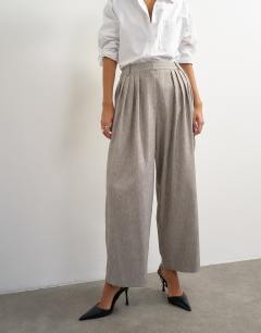 Model wearing Co ord  multi pleated wide leg trouser in taupe marl