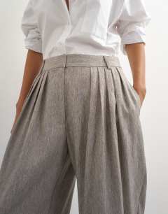 Model wearing Co ord  multi pleated wide leg trouser in taupe marl