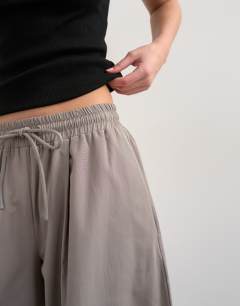 Model wearing Co ord nylon lightweight ovoid trouser in grey