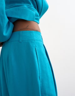 Model wearing Co ord occasion barrel trouser in turquoise