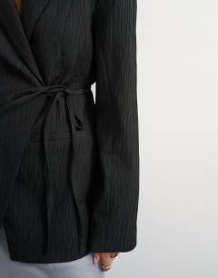 Model wearing Co ord occasion plisse tie waist blazer in black