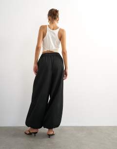 Model wearing Co ord occassion plisse balloon tie front trouser in black