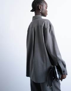 Model wearing Co ord oversized asymmetric tailored shirt in grey