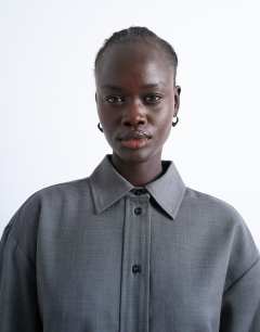 Model wearing Co ord oversized asymmetric tailored shirt in grey