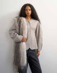 Model wearing Co ord ovoid sleeve collarless blazer in taupe marl