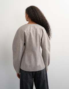Model wearing Co ord ovoid sleeve collarless blazer in taupe marl
