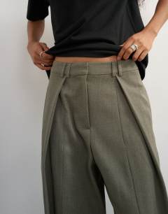Model wearing Co ord ovoid tab hem tailored trouser in stone