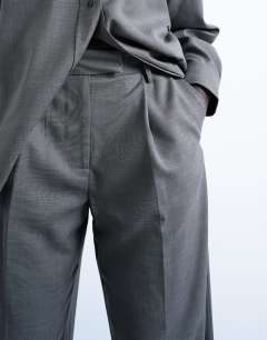 Model wearing Co ord pleated slouchy trouser in grey